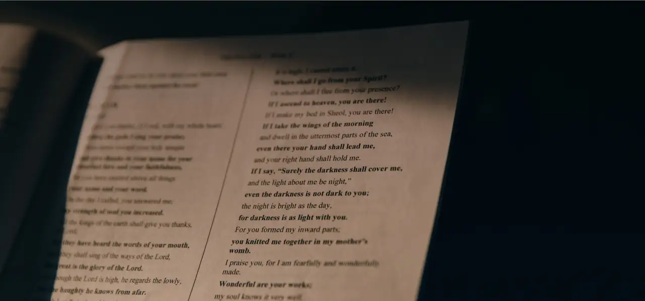 An open Bible at Psalm 139 in low light